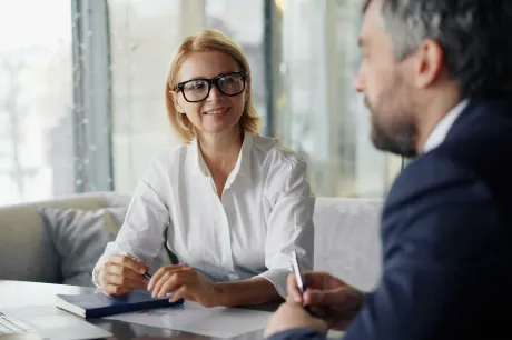Woman with glasses white shirt on desk