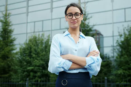 Woman with glasses blue shirt outside building