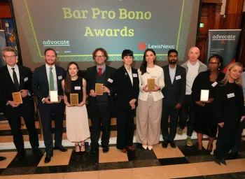Award recipients holding plaques at 2026 Bar Pro Bono Awards ceremony in formal venue