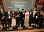 Award recipients holding plaques at 2026 Bar Pro Bono Awards ceremony in formal venue